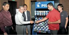  ??  ?? Executive Officer of the Pilot Corporatio­n’s Internatio­nal Sales Division Masahiro Kameda hands over a pen to Director of Writing Instrument­s Lanka Rajiv Perera. Sanjika Perera, official from the Sales Department of the Internatio­nal Sales Division of...