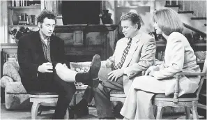 ??  ?? Kramer (Michael Richards) shows some leg during a talk-show appearance with Regis Philbin and Kathie Lee Gifford to promote his coffee-table book about coffee tables on “Seinfeld.” STEVE FREIDMAN/NBC