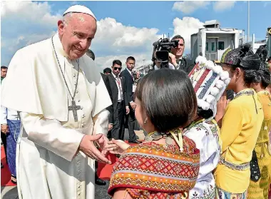  ?? PHOTO: REUTERS ?? Pope Francis is welcomed as he arrives at Yangon Internatio­nal Airport at the start of a three-day visit to Myanmar.