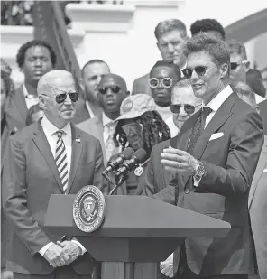  ?? MANUEL BALCE CENETA/ AP ?? President Joe Biden listens as Tom Brady speaks during the Buccaneers visit to the White House to celebrate the Super Bowl 55 win.