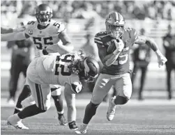  ?? TONY AVELAR/AP ?? San Francisco 49ers running back Elijah Mitchell carries against Vikings defensive tackle James Lynch on Sunday in Santa Clara, Calif.