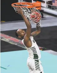  ?? Ethan Miller / Getty Images ?? USF’s Jamaree Bouyea dunks for two of his gamehigh 18 points in a victory over San Diego.