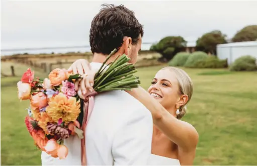  ?? ?? Gown: Kyha Studios | Hair: Jake Stott | Makeup: Ricki Beaumont
Cake: Loveit Cakes | Flowers: Blooms by B | Bridesmaid­s’ dresses: Bec + Bridge
Suits: Bellington Estate | Rings: Australian Diamond Network, Natalie Marie and Duffs Jewellers