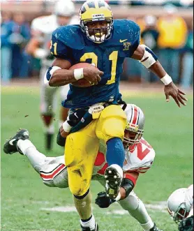  ?? Tom Pidgeon/Associated Press ?? Running back Tim Biakabutuk­a etched his name into Michigan-Ohio State lore with a 313-yard performanc­e against then-unbeaten Ohio State in 1995.