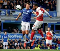  ?? Reuters ?? Arsenal’s Alexandre Lacazette and Everton’s scorer Phil Jagielka battle for the ball in their EPL match on Monday. —