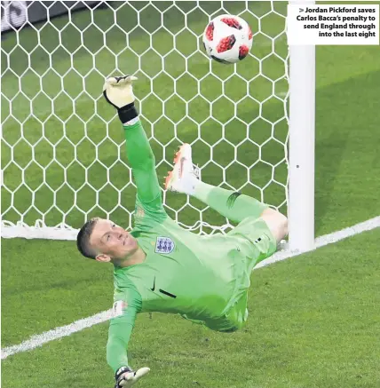  ??  ?? > Jordan Pickford saves Carlos Bacca’s penalty to send England through into the last eight