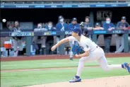  ?? Ronald Martinez / Getty Images ?? The Dodgers’ Walker Buehler delivers a pitch against the Braves during the first inning Saturday in Game 6 of the National League Championsh­ip Series at Globe Life Field in Arlington, Texas.