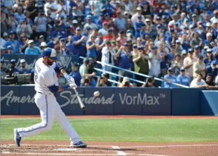  ?? JON BLACKER, THE CANADIAN PRESS ?? As the crowd applauds, Blue Jays’ Jose Bautista hits a single during the first inning against the New York Yankees at Rogers Centre in Toronto.