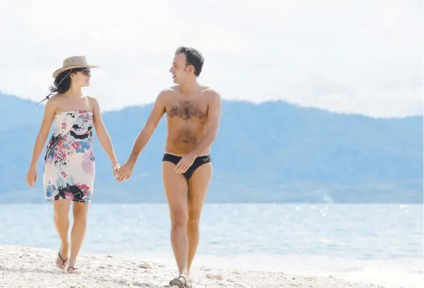  ??  ?? PICTURE PERFECT: Italian tourists Sara and Andrea Gillione take an idyllic stroll along Nudey Beach, which has just been named Australia’s best beach.