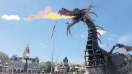  ?? DEWAYNE BEVIL/ORLANDO SENTINEL ?? A fire-breathing dragon was part of the Festival of Fantasy parade at Magic Kingdom.