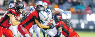  ??  ?? Toronto Argonauts running back Malcolm Williams is tackled by a host of Stampeders as the Calgary defence completely shut the door on the visiting Argos in the second half to pick up their 11th win of the season.