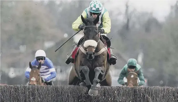  ??  ?? 0 Sam Twiston- Davies riding Clan Des Obeaux clear the last to win The Ladbrokes King George VI Chase at Kempton Park last year.