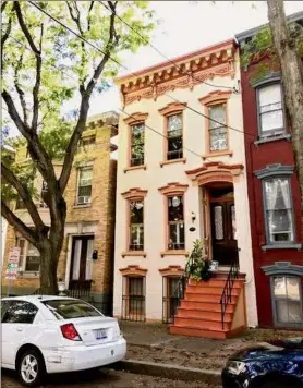  ?? ?? The home at 150 Jay St. in Albany is a three-story townhouse in Central Square. Above, one of two and a half bathrooms. At left is the garden-level apartment.