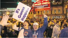  ?? MATT MARTON/THE ASSOCIATED PRESS ?? Cubs fans celebrate after the tream earned a trip to the World Series for the first time since 1945.