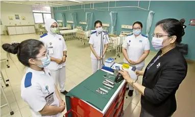  ??  ?? Back in form: Nursing students going through practical training at UOW Malaysia KDU’s George Town campus.