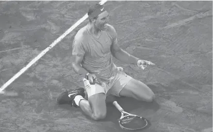  ?? CHRISTOPHE ENA/AP ?? Spain’s Rafael Nadal celebrates winning the French Open, beating Serbia’s Novak Djokovic 6-0, 6-2, 7-5 in Sunday’s final.