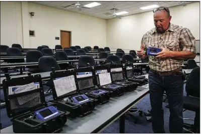  ?? Arkansas Democrat-Gazette/MITCHELL PE MASILUN ?? Russell Johnson, a contract instructor for Thermo Scientific, demonstrat­es the new TruNarc Handheld Narcotics Analyzer that the Arkansas State Police received Wednesday at state police headquarte­rs in Little Rock.