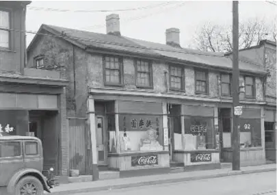  ?? CITY OF TORONTO ARCHIVES/FONDS 200 SERIES 372, SUBSERIES 33 ?? Chinese businesses on Elizabeth St. in 1937. Much of Toronto’s original Chinatown was later razed to make way for developmen­t, including the new city hall.