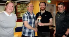  ??  ?? Winning Quiz team Ava Cullen, Cathal Kearney and Paul Cullen receive their prize from organiser Phil Kearney.