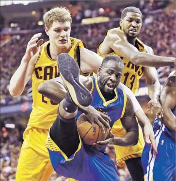  ?? Larry W. Smith European Pressphoto Agency ?? TALK ABOUT GETTING a leg up. Golden State’s Draymond Green comes up with a rebound in front of Cleveland’s Timofey Mozgov and Tristan Thompson during the Warriors’ Game 4 victory.