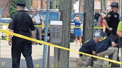  ?? [DARRELL SAPP/PITTSBURGH POST-GAZETTE] ?? Authoritie­s place evidence markers on the street and the sidewalk next to the Jefferson County Courthouse in Steubenvil­le after Judge Joseph Bruzzese Jr. was shot Monday morning. Bruzzese returned fire and survived, but his assailant, Nathaniel...