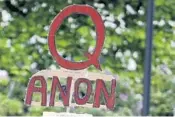  ?? TED S.WARREN/AP ?? A sign supporting QAnon is seen at a May 14 protest in Olympia, Washington. Twitter said it has suspended 70,000 accounts associated with the conspiracy theory.