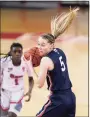  ?? Kathy Willens / Associated Press ?? UConn’s Paige Bueckers grabs the ball as St. John’s guard Unique Drake looks on during the first quarter of Wednesday’s game in New York.