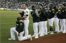  ?? ERIC RISBERG — THE ASSOCIATED PRESS ?? Oakland Athletics catcher Bruce Maxwell kneels during the national anthem before the start of a baseball game against the Texas Rangers Saturday, Sept. 23, 2017in Oakland Bruce Maxwell of the Oakland Athletics has become the firstmajor league baseball...