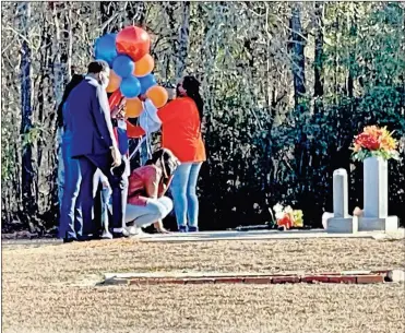  ?? AP-Lewis M. Levine ?? Wanda Cooper-Jones kneels before the grave of her son, Ahmaud Arbery, at the New Springfiel­d Baptist Church in Waynesboro, Ga., on Tuesday, Feb. 23, 2021, to mark the one year anniversar­y of Ahmaud Arbery’s death in Brunswick, Ga. White men armed with guns pursued and killed Arbery, who is Black, as he ran through their neighborho­od.