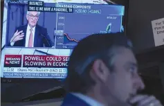  ?? (Brendan McDermid/Reuters) ?? A TRADER WORKS, as Federal Reserve Chair Jerome Powell is seen delivering remarks on a screen, on the floor of the New York Stock Exchange.