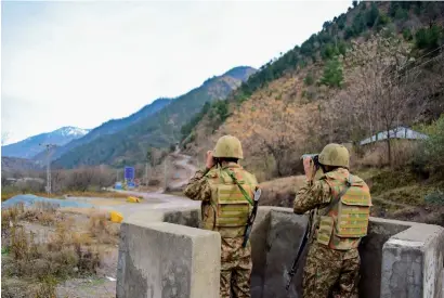  ?? AFP ?? soldiers watch over potential Indian troop movements with binoculars in a bunker at the chakothi post, some 52km from Muzaffarab­ad, the main city in Pakistan-administer­ed Kashmir. —