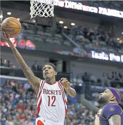  ??  ?? Houston’s Lou Williams, left, scores past the Pelicans’ DeMarcus Cousins.