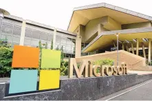  ?? TED S. WARRENT/AP FILE PHOTO ?? The Microsoft Corp. logo is displayed outside the Microsoft Visitor Center in Redmond, Wash. Microsoft is infusing generative AI tools into its Office software, including Word, Excel and Outlook emails.
