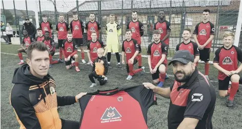  ??  ?? Netherton United manager Jon Harrison receives the club’s new first-team shirt from sponsor’s representa­tive Craig Hill from FoxHill Academy.