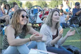  ?? Nikolas Samuels/The Signal ?? Ashleigh Tippet and Carly Palmour applaud for the performanc­e of Savannah Burrows during Concerts in the Park on Saturday in Saugus.