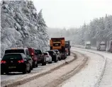  ??  ?? Hot and cold: Snow in Inverness last week and, right, firefighte­rs on Harris yesterday