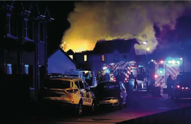  ?? Photograph: David Godziszko ?? FLAMES: Police and firefighte­rs deal with the fierce fire which consumed a house at LoganWay, Muir of Ord.