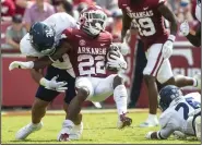  ?? (NWA Democrat-Gazette/Charlie Kaijo) ?? Arkansas finished with 245 rushing yards during Saturday’s victory over Rice, led by 102 yards on 22 carries from running back Trelon Smith (22).