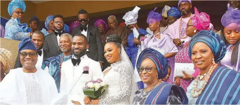  ?? ?? President, African Developmen­t Bank ( AFDB) and father of the bride, Dr Akinwumi Adesina ( left); father of the groom, Mr Fisan Bankale; Couple: Oluwasijib­omi and Tiwatuope Bankale; Mrs Yemisi Adesina; groom mother, Dr Tayo Bankale during the wedding of AFDB President’s daughter at Anglican Church of the Ascension, Opebi, Lagos… yesterday. PHOTO: NAN