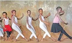  ??  ?? Young ballerinas practice under the instructio­n of Kenyan ballet dancer Joel Kioko, 16, in a room at a school in the Kibera slum of Nairobi, Kenya.