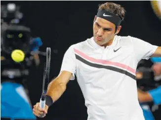  ?? THE ASSOCIATED PRESS ?? Roger Federer makes a backhand return to Hyeon Chung during their semifinal match at the Australian Open on Friday. Chung had to retire in the second set because of blisters.