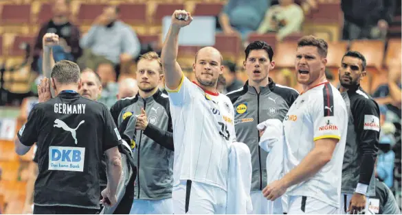  ?? FOTO: JAN WOITAS/DPA ?? Paul Drux (Mitte) freut sich mit seinen Teamkolleg­en über den WM-Auftaktsie­g gegen Katar.
