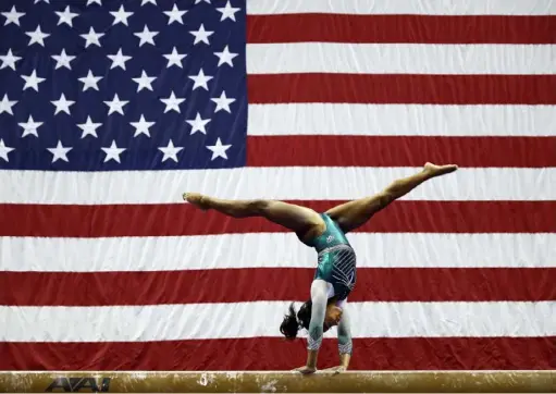  ?? Jamie Squire/ Getty Images ?? Simone Biles competes on the balance beam at the U. S. women’s gymnastics championsh­ips Friday in Kansas City, Mo.