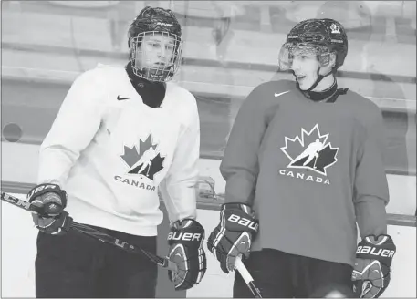  ?? Jeff Mcintosh/the Canadian Press ?? Nathan MacKinnon, left, from Cole Harbour, N.S., chats with Ryan Nugent-Hopkins from Burnaby, B.C., during the National Junior hockey camp.