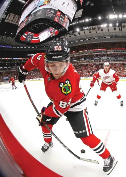  ?? JONATHAN DANIEL/GETTY IMAGES ?? Patrick Kane, who had an assist, passes the puck between his legs Wednesday night at the United Center.
