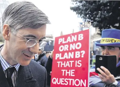  ?? PHOTO: REUTERS/ CLODAGH KILCOYNE ?? Divided we stand: Jacob Rees-Mogg walks past an anti-Brexit protester after the British parliament rejected Prime Minister Theresa May’s Brexit deal