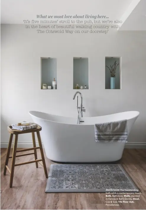  ??  ?? Bathroom The freestandi­ng bath adds a contempora­ry touch. Bath, Bathstore. Walls, painted in Farrow &amp; Ball’s Dimity. Stool, Cox &amp; Cox. Tile floor mat, Porcelanos­a.