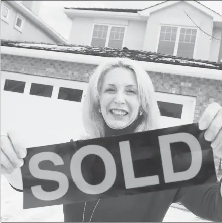 ?? Dean Bicknell/calgary Herald ?? Real estate agents in Calgary were busy in 2012 hanging out sold signs as the market for resale homes remained buoyant.