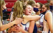  ?? JEFF GILBERT / CONTRIBUTE­D ?? Carroll’s Sarah Ochs (right) and Ava Lickliter hug as the Patriots celebrate their 57-48 victory over previously unbeaten Tippecanoe on Monday night at Tecumseh High School.