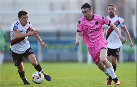  ??  ?? Dean George tries to steal a march on Bohemians midfielder Keith Buckley during Friday’s rout in Ferrycarri­g Park.